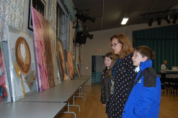 Students Diana Heming, center, and Luke David, far right, with Special Education Teacher Shelley Borkoski looking at paintings by Charles Wildbank at Our Lady of the Hamptons Regional Catholic School JON WINKLER