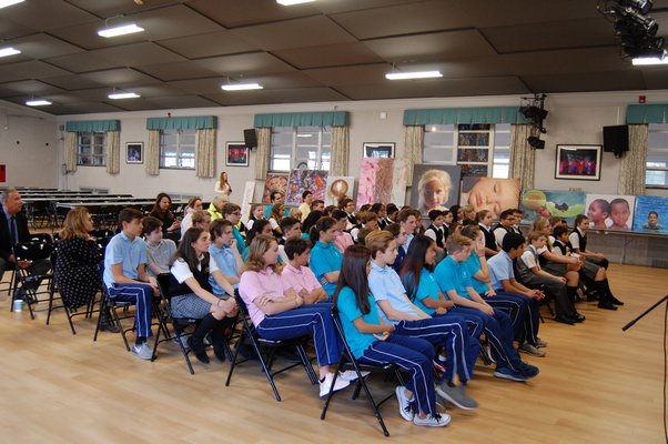 Students of Our Lady of the Hamptons Regional Catholic School listening to artist Charles Wildbank. JON WINKLER