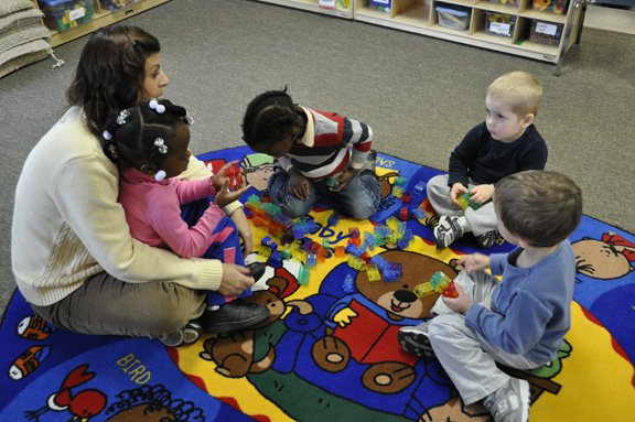 Side By Side Child Care co-owner Kelly Quartuccio plays with a group of students in the integrated class at the day care center in Southampton.