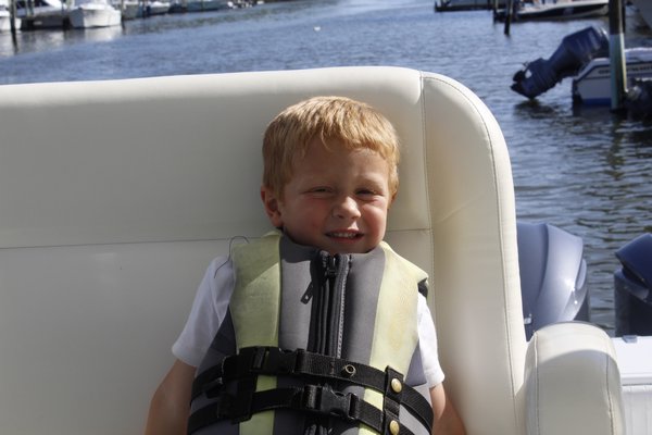 Chris Desantis takes a ride on his dad's 40-foot boat in Moriches Bay. KATE RIGA