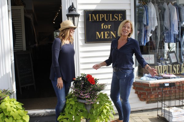 Jaime Sussillo, owner of Chic, and Liz Lambrecht, owner of Impulse for Men, stand in front of their Main Street businesses. KATE RIGA