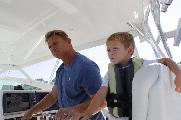 Gregg Desantis, Center Moriches boater and resident, takes his sons out for a ride on his 40-foot boat in Moriches Bay. KATE RIGA