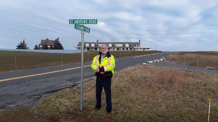 Southampton Town Highway Superintendent Alex Gregor next to a newly installed sign at the intersection of Tuckahoe Road and St. Andrews Road, on December 31, 2018. COURTESY ALEX GREGOR