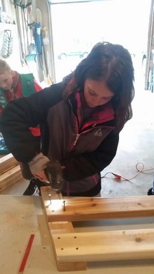 Girl Scout Sophia Fratello works on building a bench for her Bronze Award project. COURTESY ABBIE DERMODY