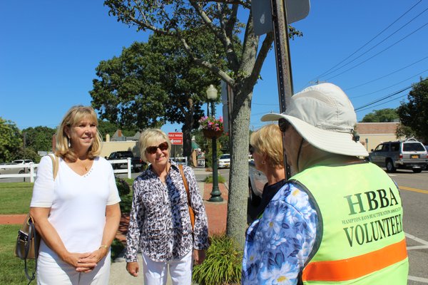 Susan von Freddi, the president of HBBA, speaks with other group members about an upcoming beautification project for the group. ALEXANDRA TALTY