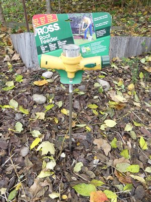 The Ross root feeder attaches to a garden hose and the proprietary fertilizer is added to the plastic reservoir on top. The hose water is forced through the reservoir, where it picks up the fertilizer and delivers it through the "needle" into the tree root zone. Prices range from $20 to $30. ANDREW MESSINGER