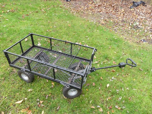 This garden cart has floatation tires, sides that fold down to create a flat surface and the end of the handle is easily removed leaving a hitch for attaching the cart to a tractor or riding mower. Great for moving around plants in pots, tools, stakes, bags of fertilizer, bags of soil and more.  ANDREW MESSINGER