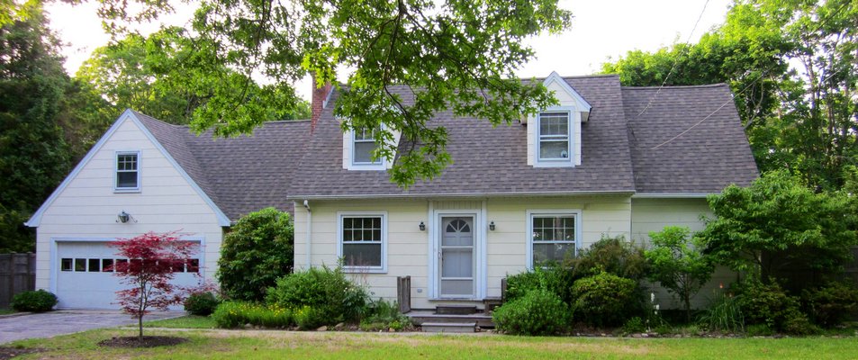 This 1,600-square-foot, four-bedroom house in Hampton Bays is listed at $400,000. COURTESY DOUGLAS ELLIMAN REAL ESTATE