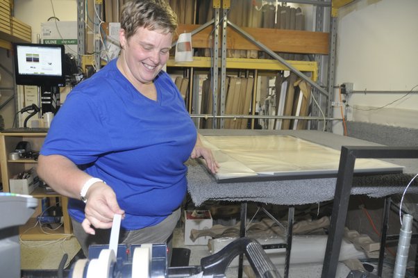 Production associate Elise Roth boxes up a digital thermal print at Modern Digital canvas to be shipped off. MICHELLE TRAURING