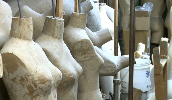 Symbol of a changing industry: scarred mannequins are relegated to forgotten storage rooms.