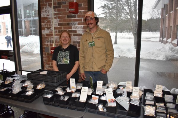 Long Island Regional Seed Consortium volunteer Megan Wingert and Brendan Tully of Youngs Farm in Old Brookvlle sell seeds at the Long Island Regional Seed Consortium's third annual seed swap. BRENDAN J. O'REILLY