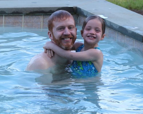 Gavin Byrne and his daughter, Louisa, enjoy the family pool in Quogue. COURTESY GERRY BYRNE