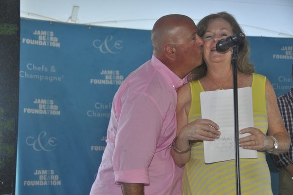 Andrew Zimmern plants a kiss on Susan Ungaro. MICHELLE TRAURING