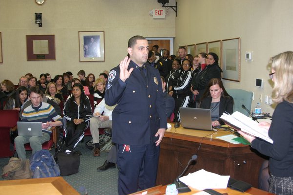 Newly hired and newly promoted police officers were sworn in at Town Hall on Tuesday night. M. Wright