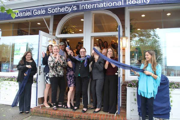 Daniel Gale Sotheby’s International Realty President and CEO Patricia Petersen cuts the ceremonial ribbon celebrating the grand opening of Daniel Gale Sotheby’s International Realty’s Westhampton Beach office on Thursday, May 25. The location, 100 Main Street, was formerly Norma Reynolds Sotheby’s International Realty. Agents and employees of  Daniel Gale offices all over Long Island attended. COURTESY DANIEL GALE SOTHEBY'S