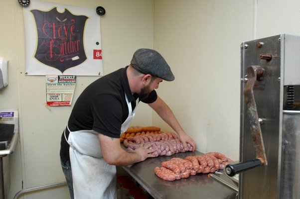 Butcher Steven Colabella at work making sausage at Peconic Prime Meats in Southampton Village. DANA SHAW