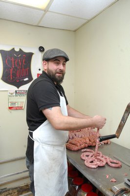 Butcher Steven Colabella at work making sausage at Peconic Prime Meats in Southampton Village. DANA SHAW
