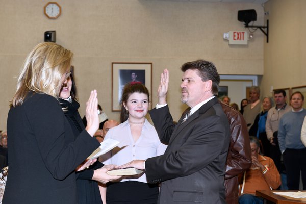 Tommy John Schiavoni is sworn in by Suffolk County Legislator Bridget Fleming.