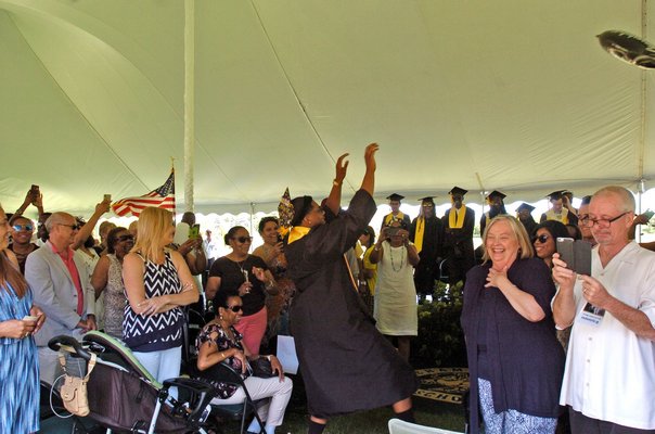Bridgehampton senior Elijah Jackson dances into the tent at graduation on Sunday.