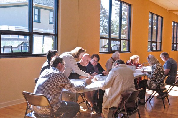 Deputy Town Assessor Maureen Berglin works with residents grieving their taxes at the St. Rosalie's Community Center Auditorium in Hampton Bays on Tuesday morning.  DANA SHAW
