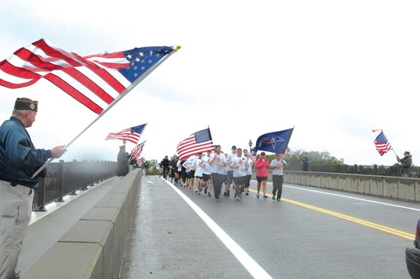 May 30: Members of the 3rd Battalion, 25th Marines, began their run to Ground Zero in New York City from the Montauk Lighthouse early Saturday morning. At mid-morning they crossed the Lance Corporal Jordan Haerter Bridge in Sag Harbor while 48 veterans lined the bridge holding flags.
