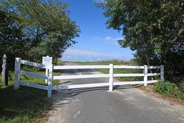 The St. Andrews Road extension, which cuts through the Shinnecock Hills Golf Club, is blocked off by a fence. DANA SHAW