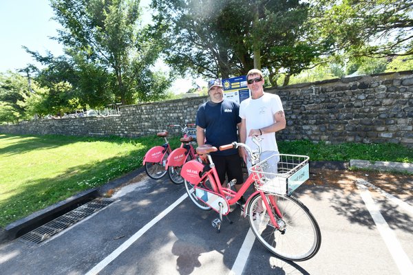 Chris Dimon and Patrick O'Donoghue at the Pedalshare station at Agawam Park in Southampton Village.    DANA SHAW