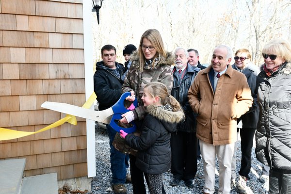 Stacey DiStefano and dughter Madison cut the ribbon on their home.  DANA SHAW