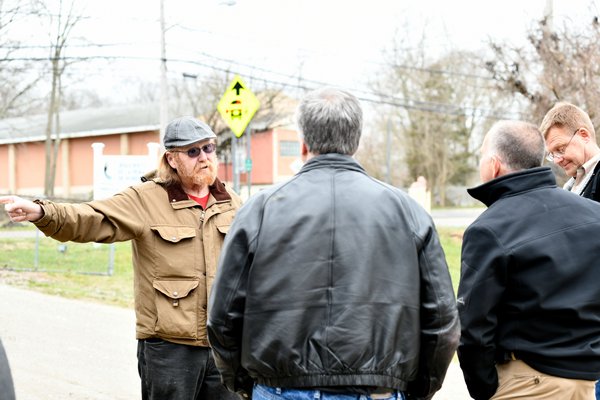 Terry Flanagan of Flanders, left, confronts officials from PSEG about the osprey nest on Tuesday.  DANA SHAW