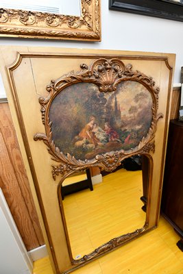 The type of mirror one doesn't see every day because they're rare: French trumeau mirrors feature a painting, usually a romantic scene, above the actual mirror and both are set off with lots of gilded moldings as this one is.  DANA SHAW