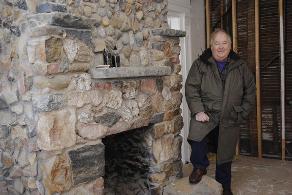 John Eilertsen, executive director of the Bridgehampton Museum, stands next to a fire place in the Nathaniel Rogers house is expected to reopen in 2019. AMANDA BERNOCCO