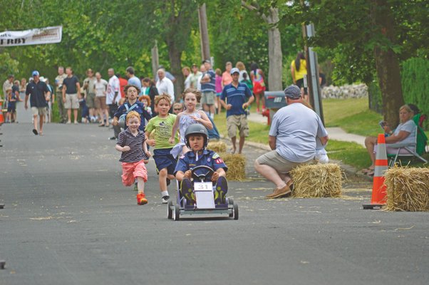 July 4: A few hundred residents lined High Street on Sunday to watch the inaugural Sag Harbor Soap Box Derby, which celebrated two hometown heroes, honored a fallen Marine and former Scout, and brought the town back to a simpler time.