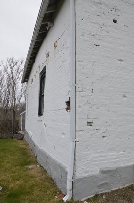 The 1838 Keeper's Quarters at Montauk Point is in need of restoration. Its walls buldge out and its bricks are beginning to crumble. SHAYE WEAVER
