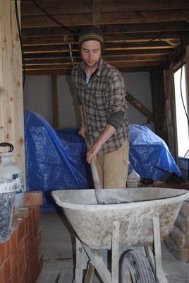 Kristian Moore of Pawlet, Vermont mixes a clay that will be used to restore a cooking oven from the 1700s. AMANDA BERNOCCO