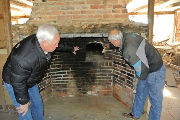 Larry Jones and Bob Hirt examine the bake oven.