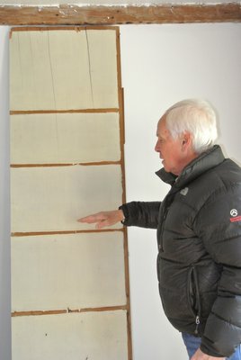 Larry Jones with one of the wide wooden planks found in the house.
