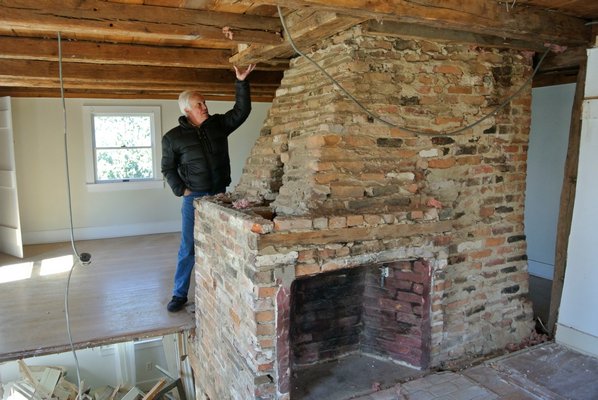 Larry Jones shows some of the original timber beams on the second floor of the house.