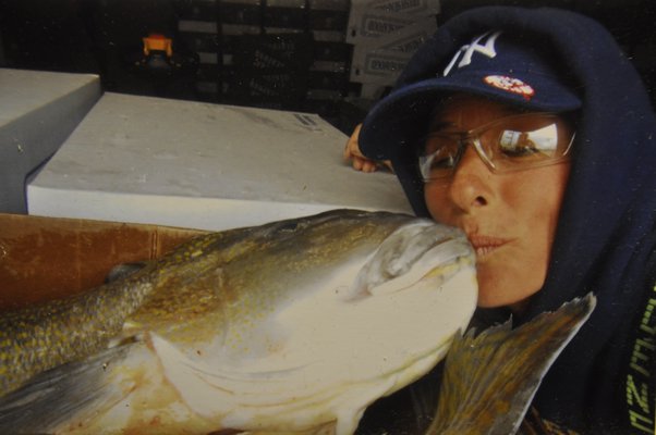 Wendi Blair puckers up to a fish. MICHELLE TRAURING