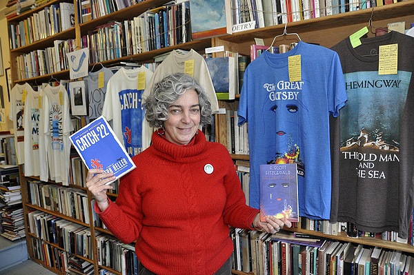 Maryann Calendrille compares "Catch-22" and "The Great Gatsby" to their T-shirt counterparts, which feature the first-edition book covers. MICHELLE TRAURING