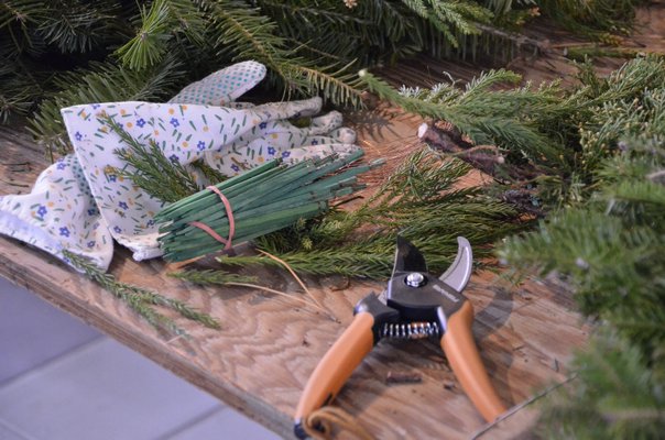 Prepare with gloves, a  pruner and picks, which you can use to secure additions to your wreath. SHAYE WEAVER