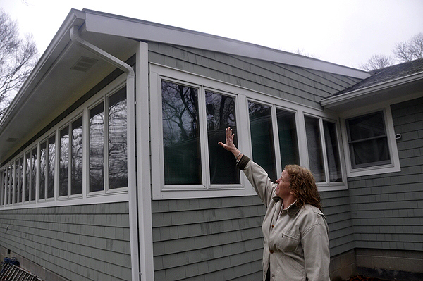Helen Dykeman explained the troubles she had with the bad contractor, who incorrectly lined up the gutters on her Southampton home. MICHELLE TRAURING