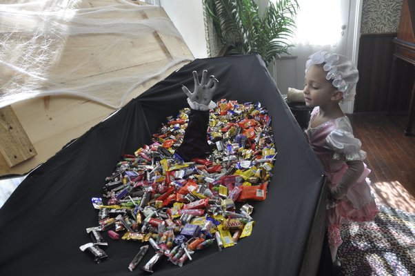 A trick-or-treater eyes the candy. MICHELLE TRAURING