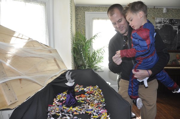 Scott Schwanbeck hands his son, Jack, a piece of candy. MICHELLE TRAURING