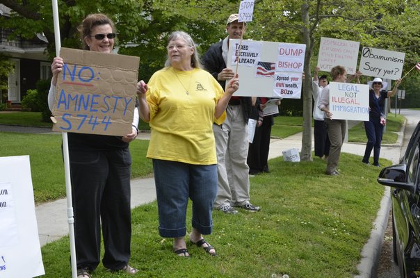 Protesters outside U.S. Representative Tim Bishop's Southampton Office on Tuesday. BY SHAYE WEAVER