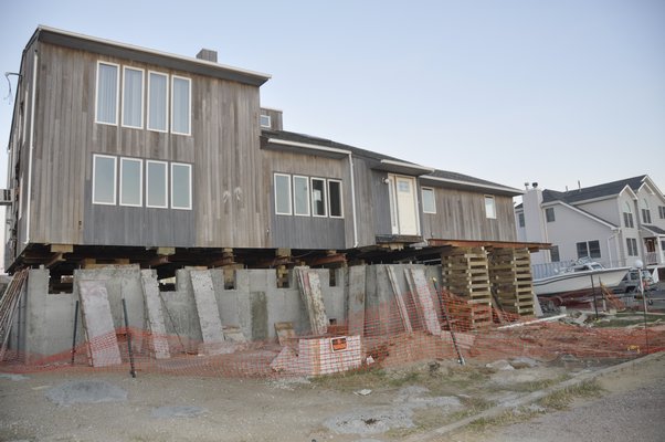 Some waterfront homeowners in East Quogue are raising their houses to comply with new elevation regulations. MICHELLE TRAURING