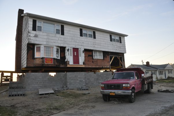 Some waterfront homeowners in East Quogue are raising their houses to comply with new elevation regulations. MICHELLE TRAURING