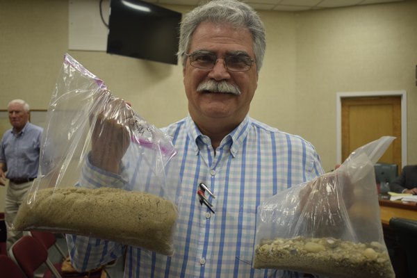 Aram Terchunian, the chief environmental analyst for the project and the owner of First Coastal, holding sand samples taken from the beach. JEN NEWMAN