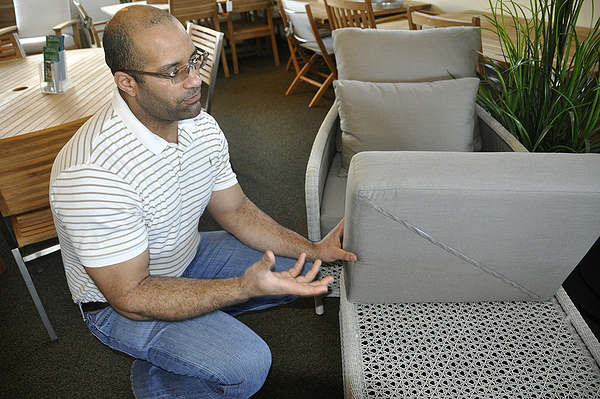 Zerach Michel shows off a box chaise cushion in a grey, which hides dirt and doesn't overheat. MICHELLE TRAURING