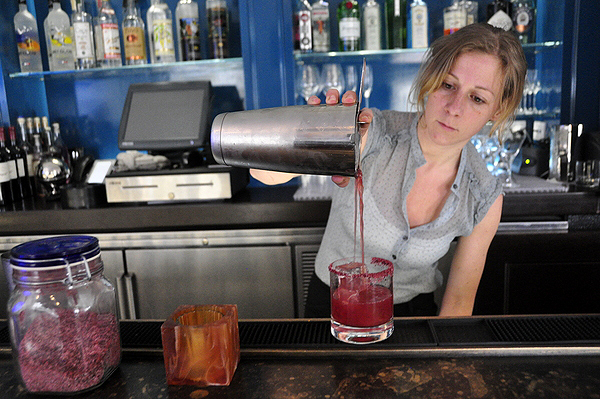 Jessica Koenig makes a Beetarita behind the bar at Topping Rose House in Bridgehampton. MICHELLE TRAURING