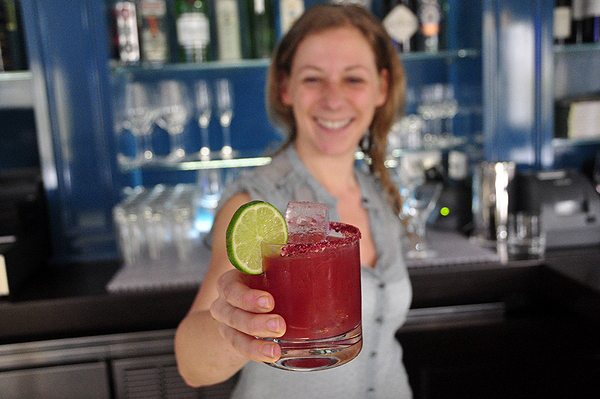 Jessica Koenig makes a Beetarita behind the bar at Topping Rose House in Bridgehampton. MICHELLE TRAURING